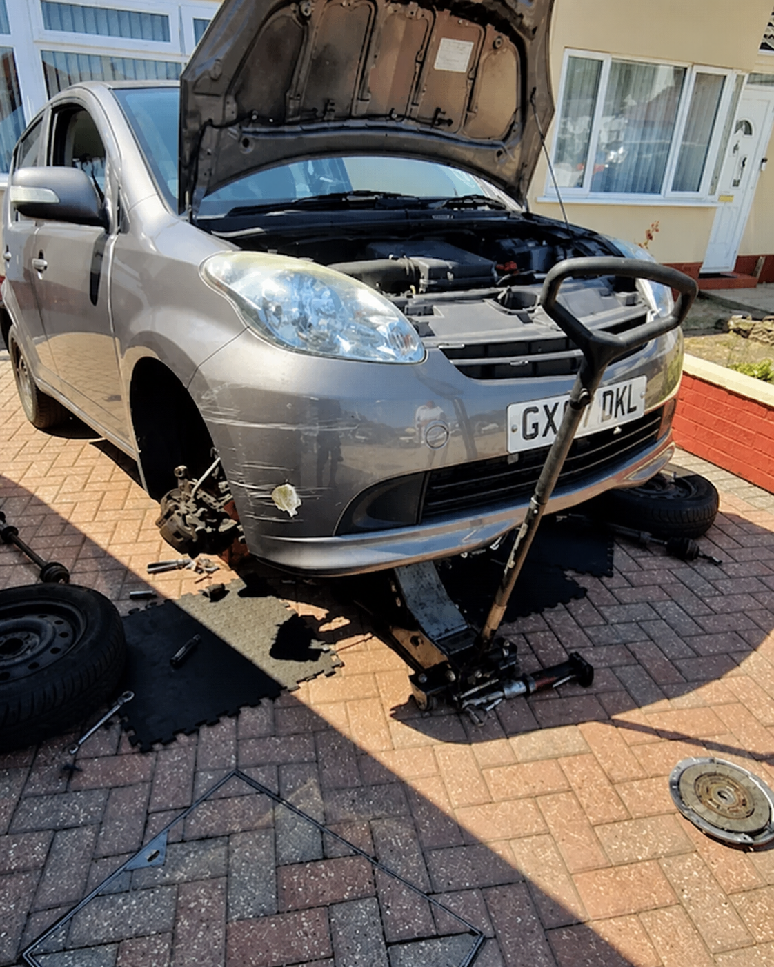 Mobile mechanic working on a car at a customer address in Leicester